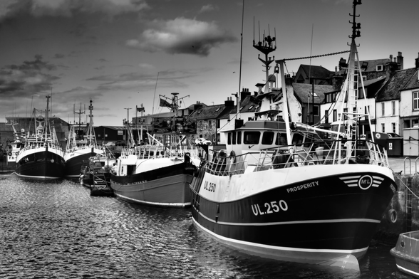 a monochrome wall art picture brings out the whites and blacks of Scottish Fishing boats at a harbour on the north east coast of Scotland 