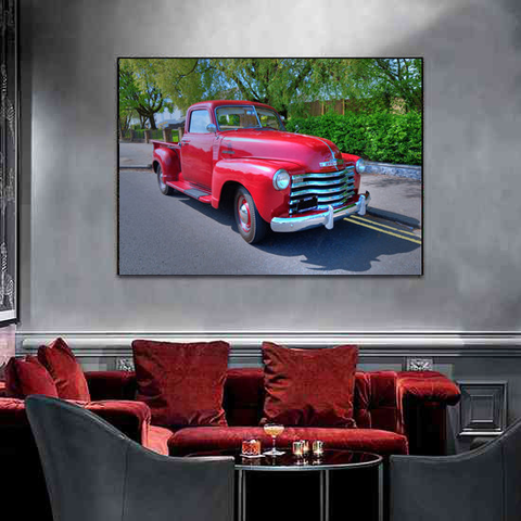 An image of and a red themed interior featuring a wall art of a 1949 Big Red Chevrolet 3100 Side Step Pick Up.
